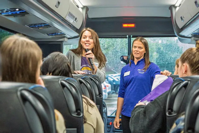 Students listening on a bus during the Cedar Valley Career Crawl