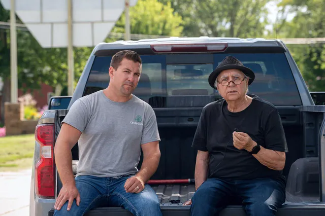 Two men talking in the bed of a pickup truck during a brand film interview