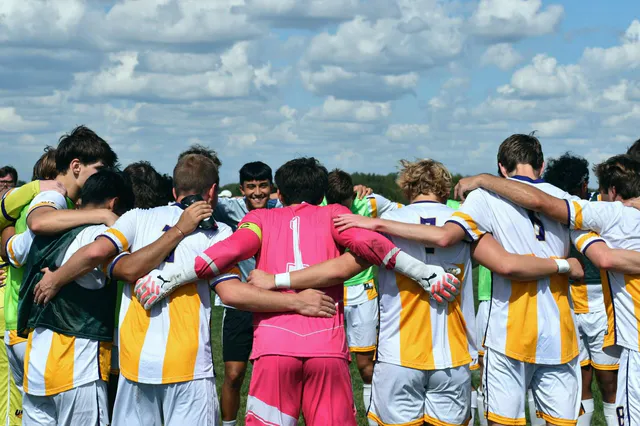 Soccer team huddled together before a match